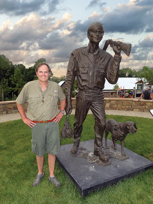 bsa sportsman eagle scout joe crafton jr posing next to his statue